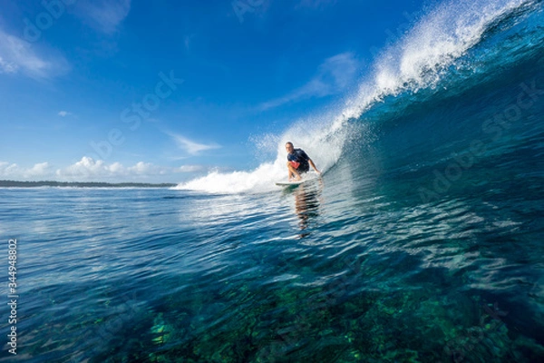 Obraz muscular surfer riding on big waves on the Indian Ocean island of Mauritius
