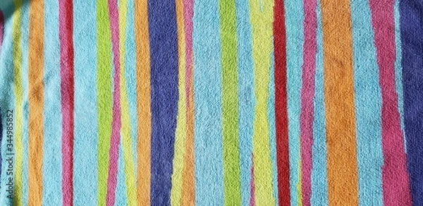 Fototapeta Bright, colorful striped design on a beach towel.