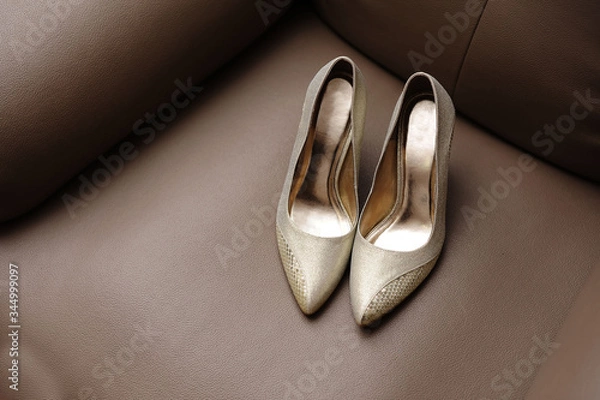 Obraz wedding shoe on brown sofa