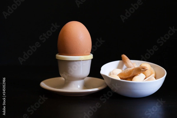 Obraz soft boiled egg in eggcup and breadsticks