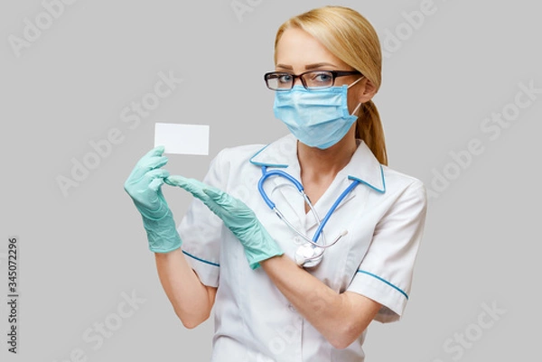 Obraz Doctor or woman nurse showing blank empty card with copy space