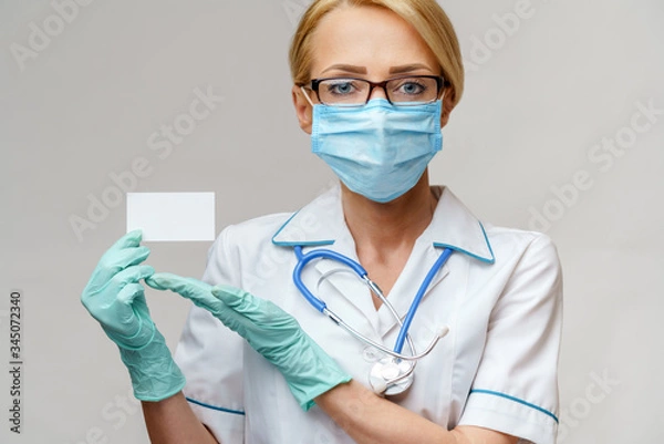 Obraz Doctor or woman nurse showing blank empty card with copy space