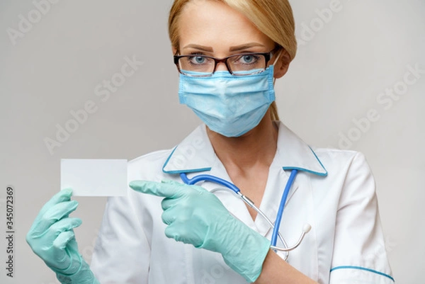 Obraz Doctor or woman nurse showing blank empty card with copy space