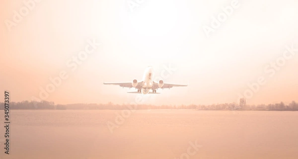 Obraz Airplane over the lake and red sunset