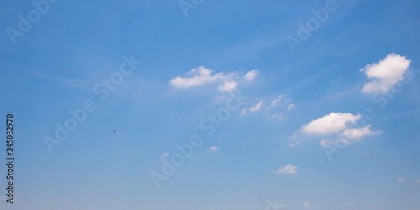 Obraz Blue sky background with clouds.