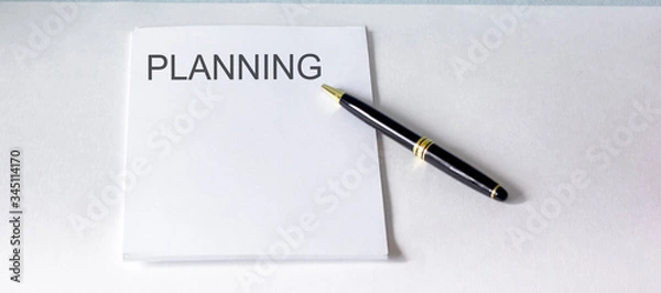 Fototapeta White notebook with planning text on a white background with pen