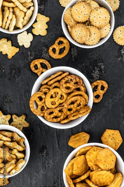 Fototapeta Mixed Snacks on dark background (close up shot; selective focus)