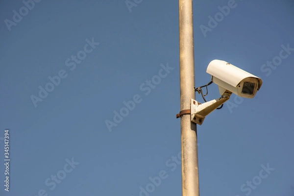 Obraz security camera on blue sky