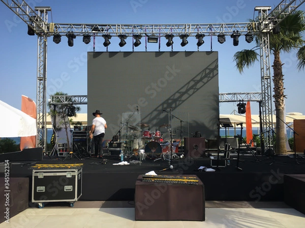 Fototapeta Open air show stage set up with led screen, sound and light system. Back line with drums.