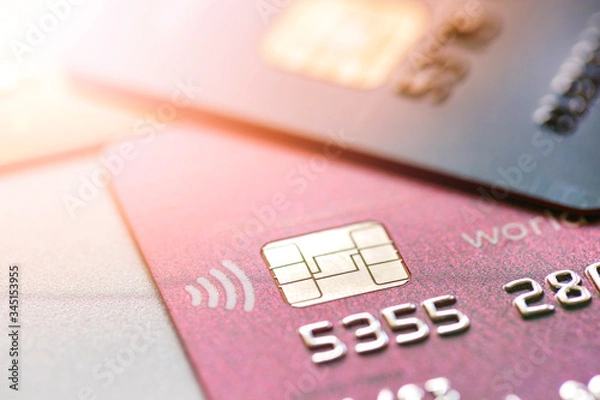 Fototapeta Close-up bank card with chip and passpass system with sun flare