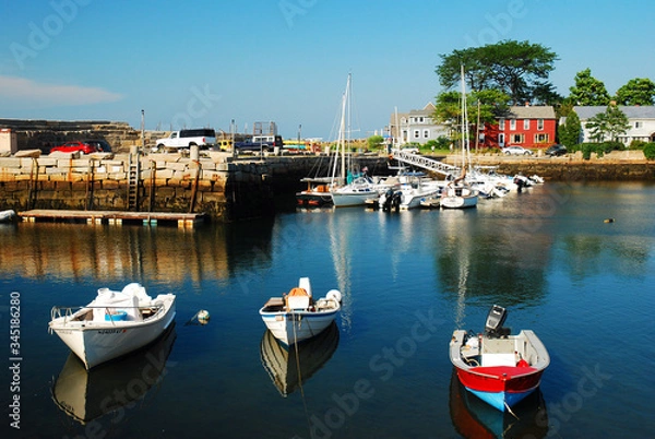Obraz Boats rest in a calm harbor at Rockport, Massachusetts
