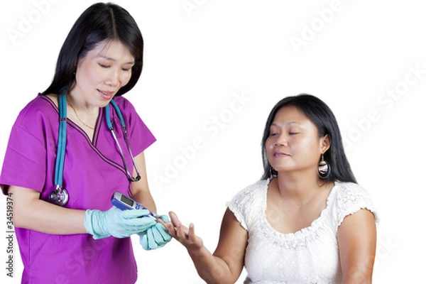 Obraz Asian nurse checking glucose