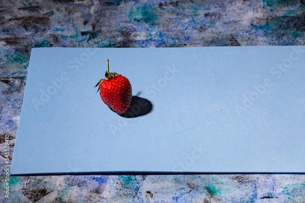Obraz red strawberry on a blue background
