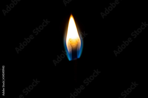 Fototapeta Burning match stick with yellow flame close up still