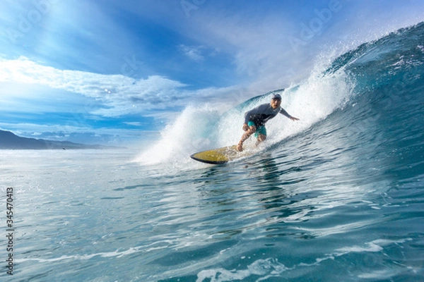 Fototapeta surfer riding on big waves on the Indian Ocean island of Mauritius