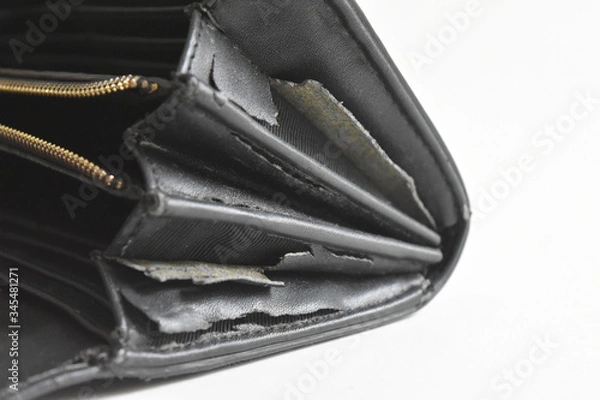 Fototapeta The artificial old leather bag black. Damage to the side and broken pattern texture background.