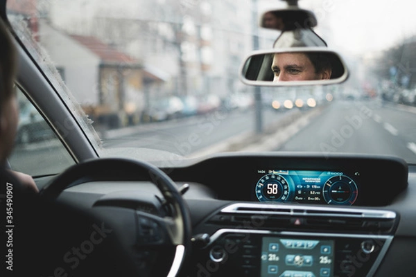Obraz Driver in a high tech car driving on the street.