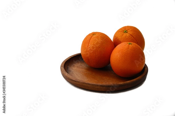 Obraz Oranges on a wooden plate