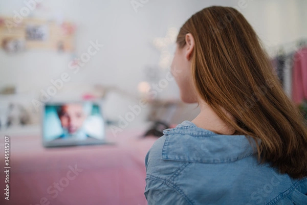 Fototapeta Beautiful happy young girl with laptop sitting and smiling, online dating concept.