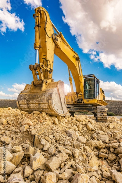 Obraz Excavator in a quarry extracting stone