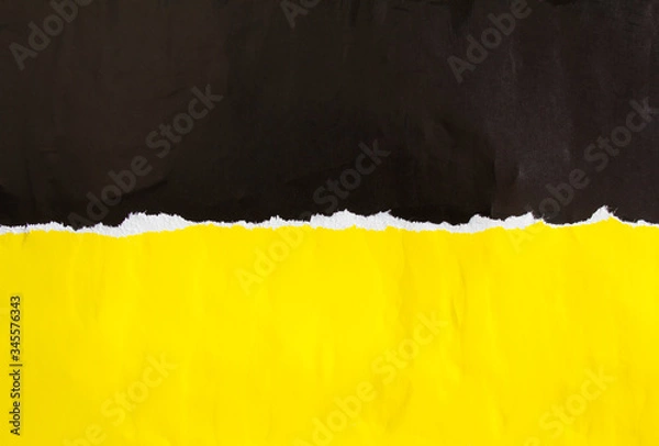 Fototapeta Black and yellow torn and crumpled paper poster. Old dirty ripped and peeling grunge paper placards texture background. Copy space for text.