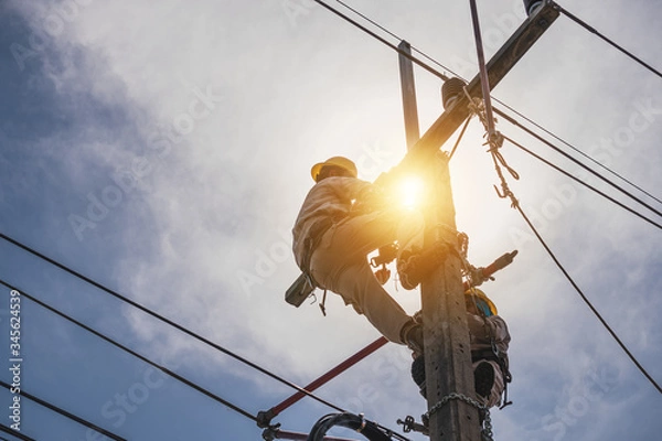 Fototapeta The power lineman is replacing the damaged insulator. That causes a power outage with protective equipment that is insulated and wearing personal protective equipment such as safety belt, helmet.