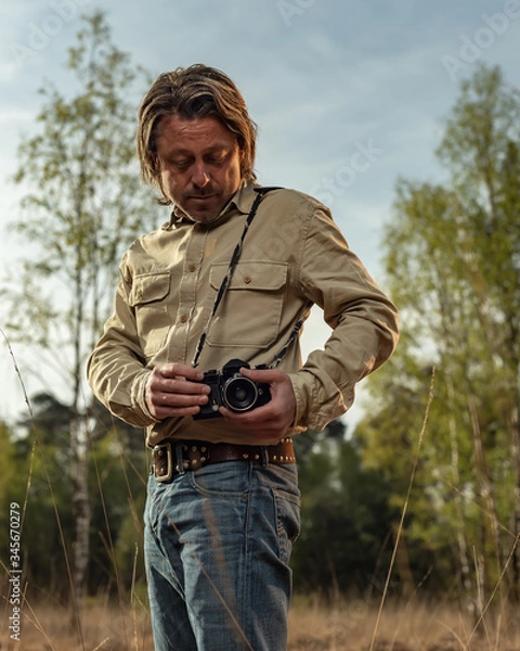 Obraz Nature photographer in nature reserve at sunrise during spring.
