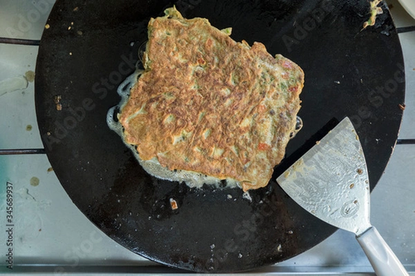 Fototapeta "Murtabak" or pancake with mixed meat or chicken and vegetable is cooking