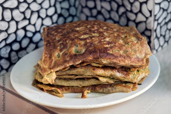 Fototapeta "Murtabak" or pancake with mixed meat or chicken and vegetable on the plate