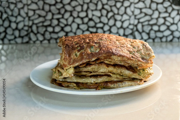 Fototapeta "Murtabak" or pancake with mixed meat or chicken and vegetable on the plate