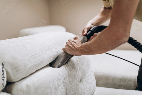 Fototapeta Process of deep furniture cleaning, removing dirt from sofa. Washing concept.