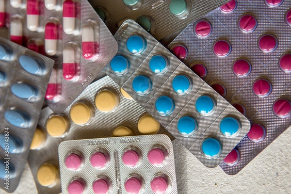 Obraz blisters of tablets of different colors - red, pink, green, blue pills and capsules