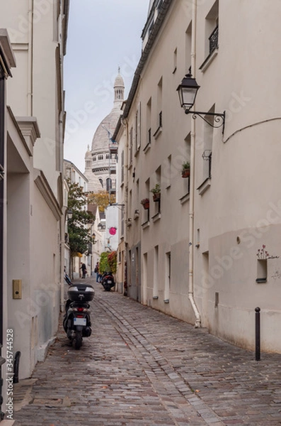 Fototapeta a little quiet street in Montmartre, with the Sacré coeur at the end of it