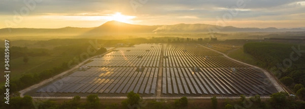 Obraz Aerial view of the solar panel with a sunny sky at sunrise.  Concept of clean energy conservation. Banner panorama background
