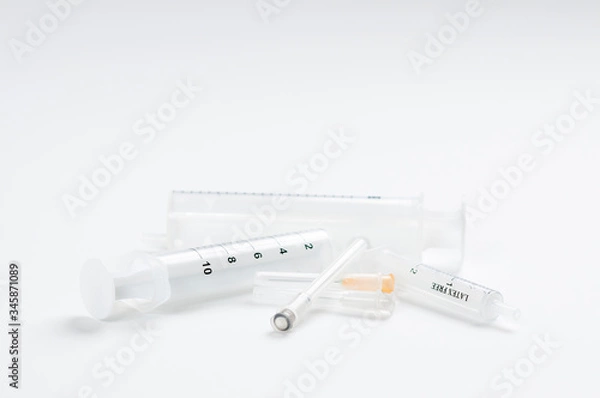 Obraz Empty syringes and needles on white background in studio, Covid-19