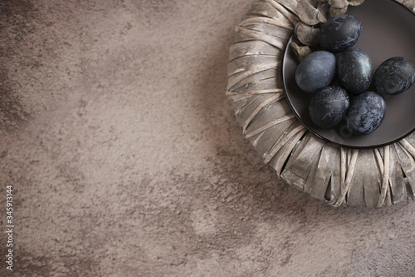 Obraz  Six dark colored eggs on a plate