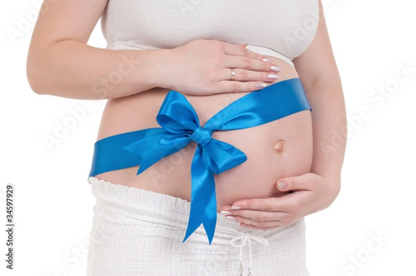 Fototapeta Pregnant belly with blue ribbon