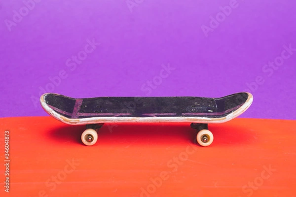 Fototapeta Small skateboard on color background. tiny skate for fingers. fingerboard close up