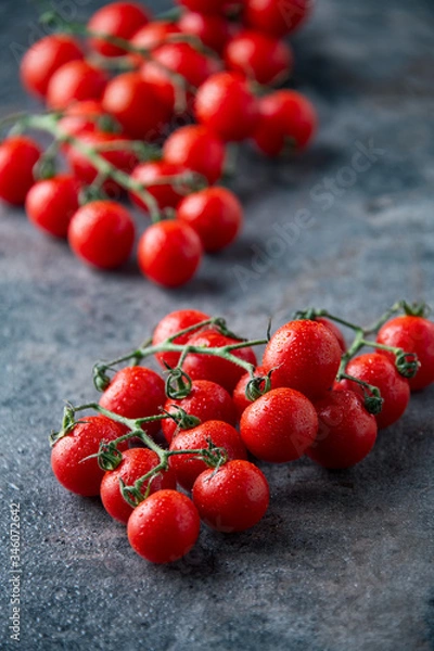 Obraz Fresh cherry tomatoes on dark background.