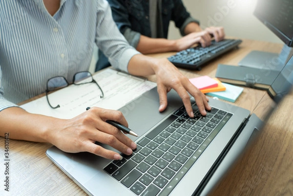 Fototapeta Collaborative work Software engineers website developer technologies or programmer working coding on startup ai application project on screen with partner in coworking space office company.