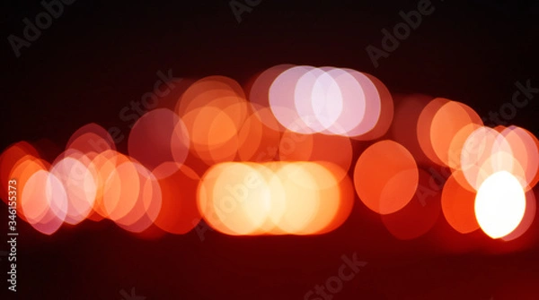 Obraz Red and orange holiday bokeh. Bokeh photo of LED light. Abstract defocused of red and yellow LED light on black background. Red and yellow bokeh. 