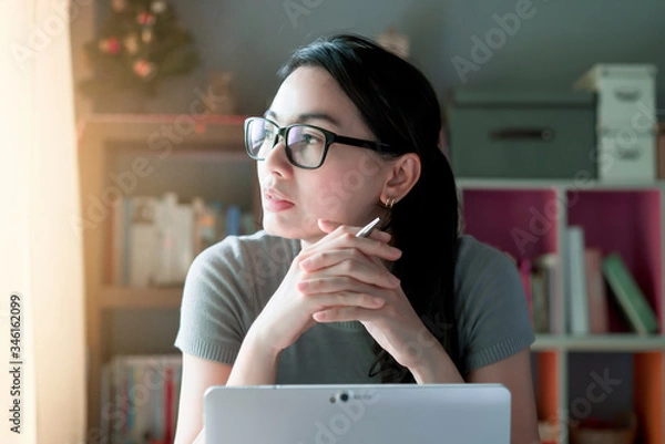 Obraz Woman thoughtful about work at home office desk laptop
