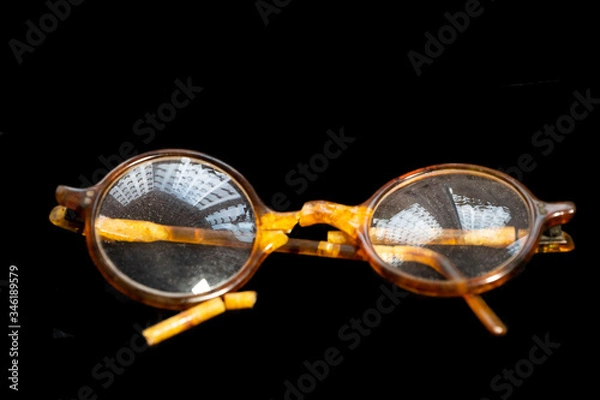 Obraz Broken old glasses on a black background