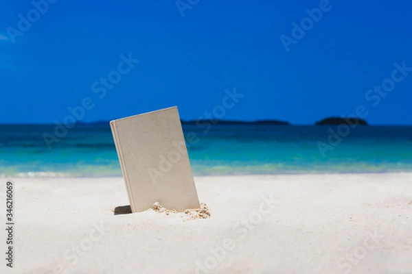Fototapeta Book on the Beautiful ocean beach On the outdoor blurred sea background