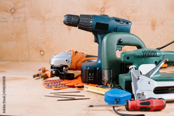 Fototapeta Electric building and crafting instruments and tools on the wooden background