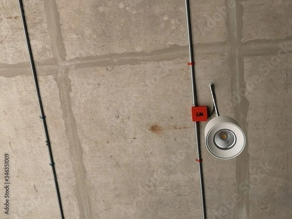 Fototapeta luminaire installed inside the building with a concrete surface ceiling