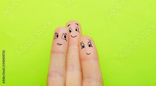 Fototapeta the concept of three fingers as a man a woman and a child hug together and love each other