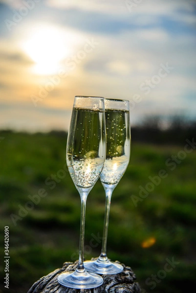 Obraz 
champagne glasses at sunset