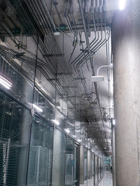 Obraz passing daylight inside office building on modern glass building interior corridor