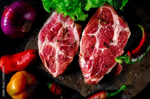 Obraz Two fresh raw ribeye steak on the stone on wooden background with salt, pepper